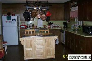 5219 Morgan Mill Road Monroe, NC 28110 - Photo 3 of 6 a kitchen with a stove and a clock