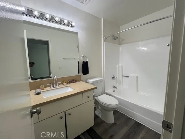 a bathroom with a sink toilet a mirror and shower