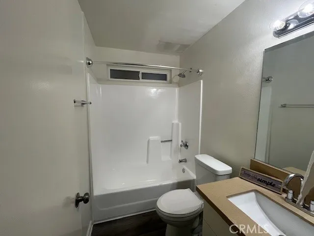 a bathroom with a granite countertop toilet sink and shower