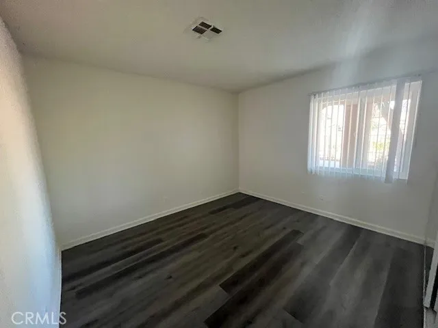 a view of an empty room and wooden floor
