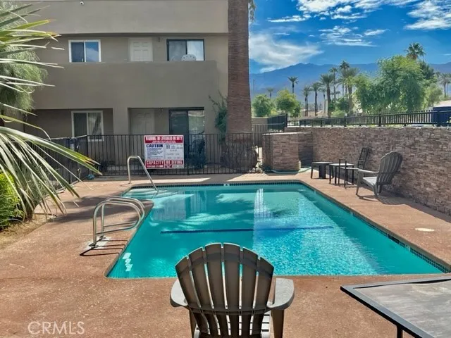 a view of a patio with chairs and a table