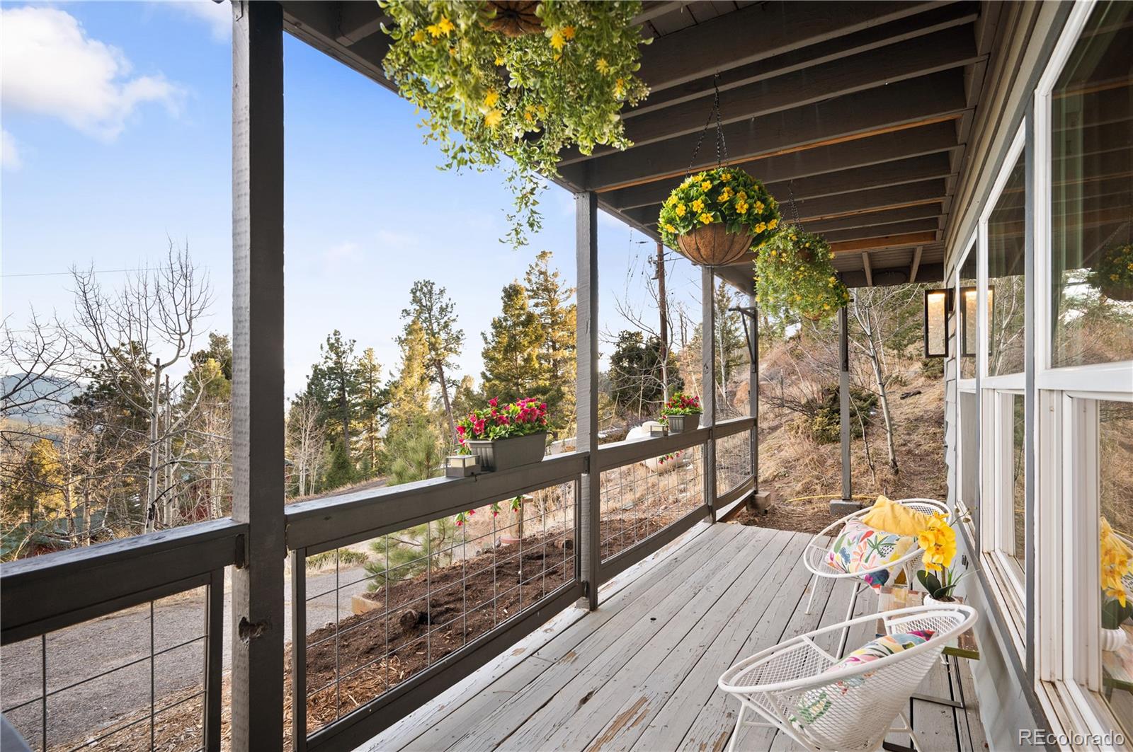 11740 Baca Road Conifer, CO 80433 - Photo 8 of 49 a view of a balcony with wooden floor