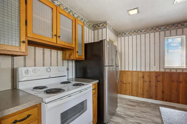 a kitchen with a stove and a refrigerator