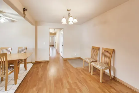 a view of a livingroom with furniture wooden floor and a window