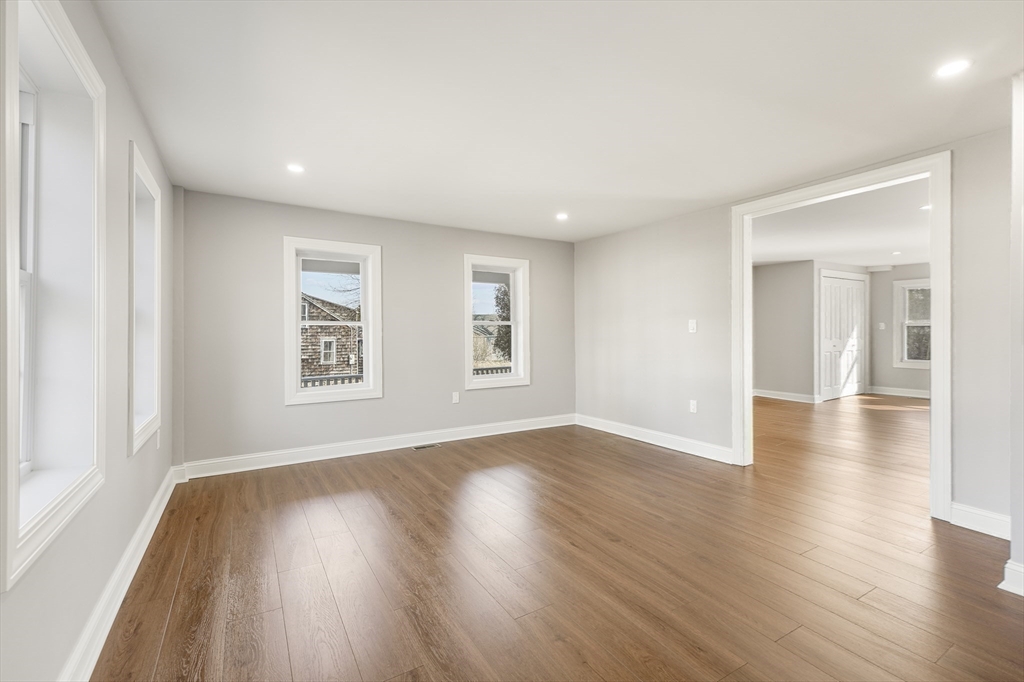 26 Maple Street Mendon, MA 01756 - Photo 16 of 42 an empty room with wooden floor and windows