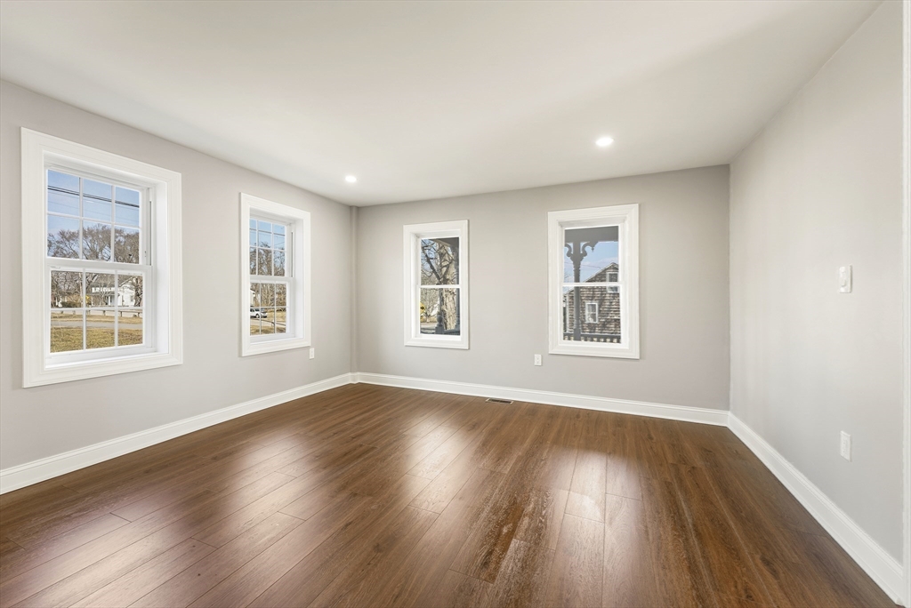 26 Maple Street Mendon, MA 01756 - Photo 17 of 42 a view of an empty room with wooden floor and a window