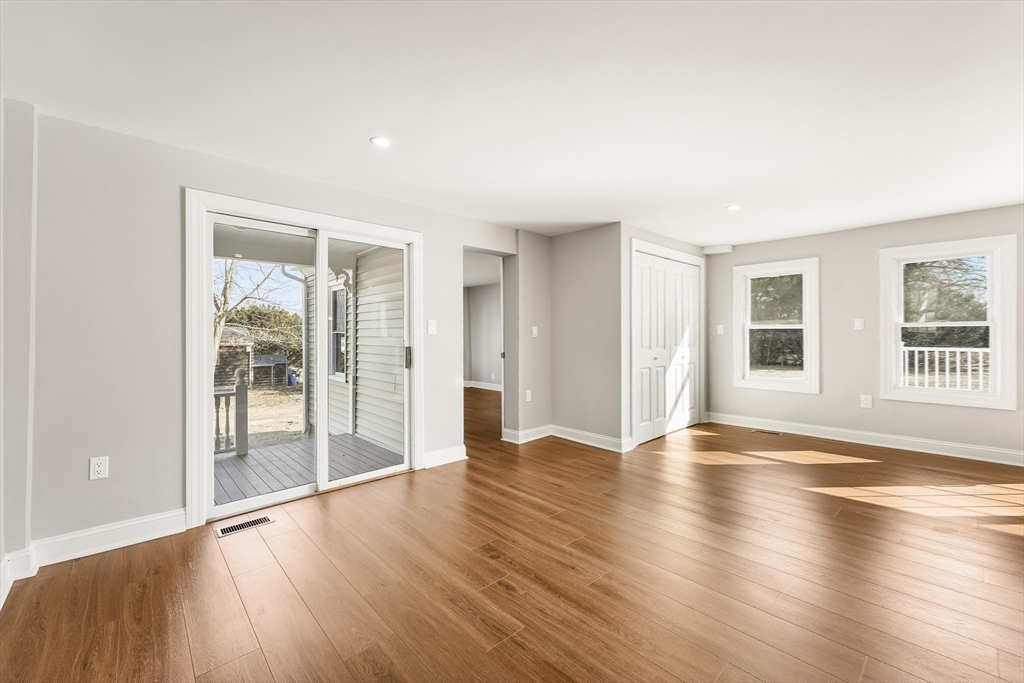 26 Maple Street Mendon, MA 01756 - Photo 19 of 42 a view of an empty room with wooden floor and a window