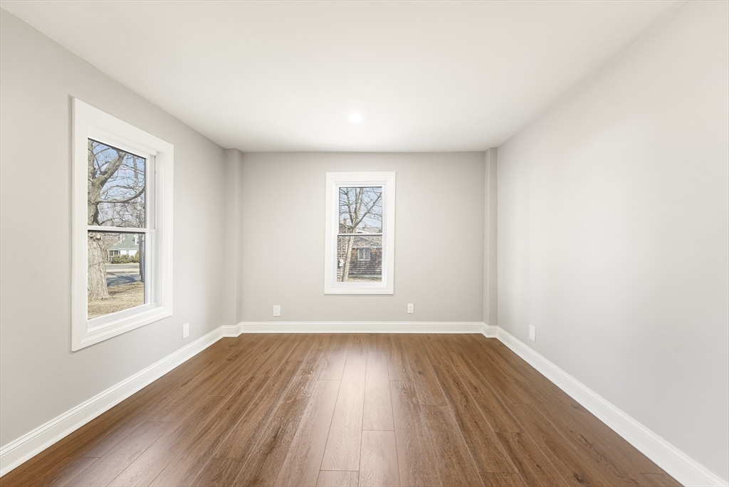 26 Maple Street Mendon, MA 01756 - Photo 24 of 42 an empty room with wooden floor and windows