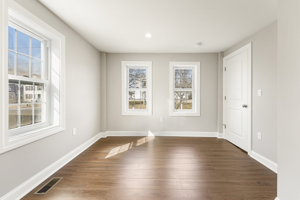 26 Maple Street Mendon, MA 01756 - Photo 27 of 42 an empty room with wooden floor and windows