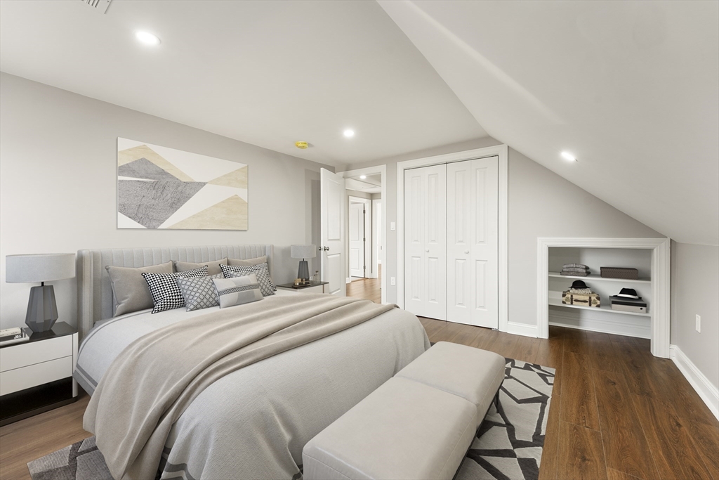 26 Maple Street Mendon, MA 01756 - Photo 28 of 42 a bedroom with a large bed and a wooden floor