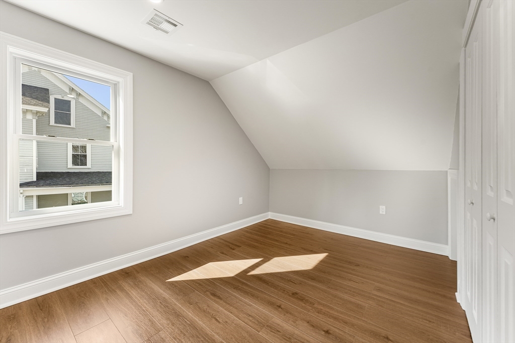 26 Maple Street Mendon, MA 01756 - Photo 30 of 42 an empty room with wooden floor and windows