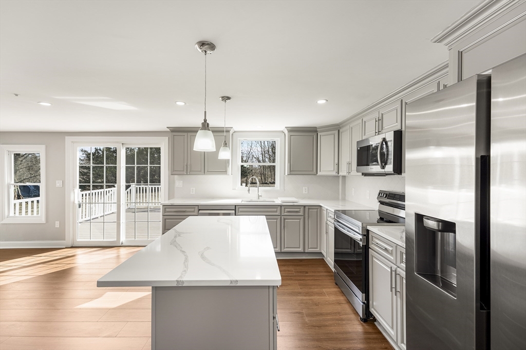26 Maple Street Mendon, MA 01756 - Photo 3 of 42 a kitchen with stainless steel appliances granite countertop a sink stove and refrigerator