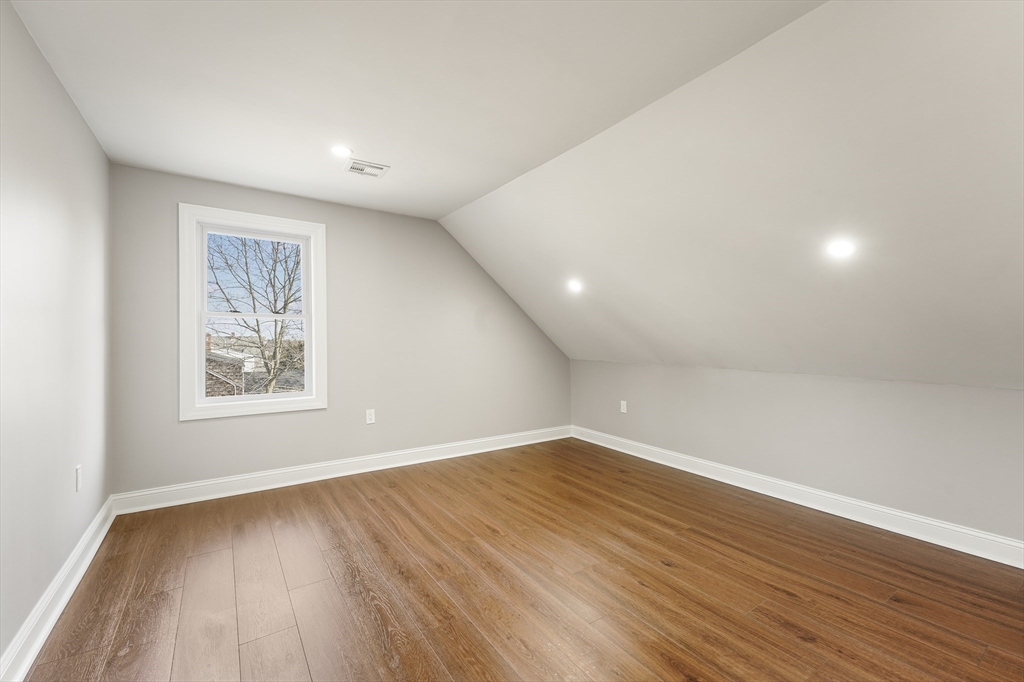 26 Maple Street Mendon, MA 01756 - Photo 33 of 42 an empty room with wooden floor and windows