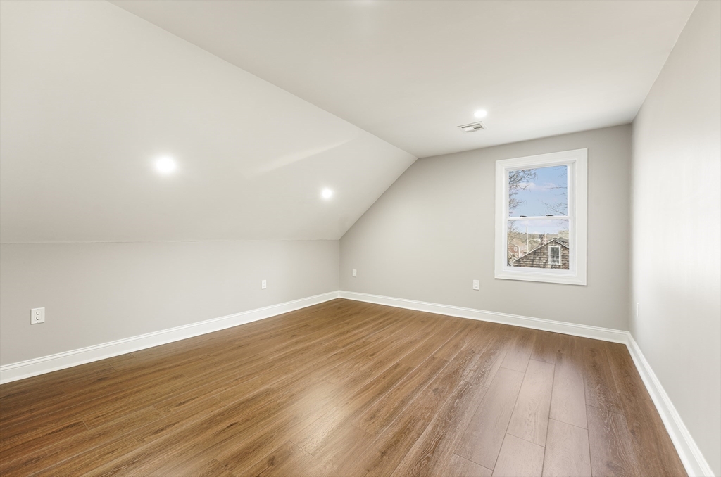 26 Maple Street Mendon, MA 01756 - Photo 35 of 42 an empty room with wooden floor and windows