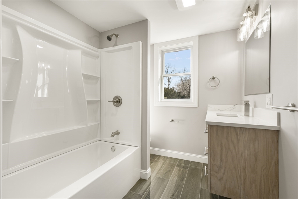 26 Maple Street Mendon, MA 01756 - Photo 36 of 42 a bathroom with a tub sink and mirror