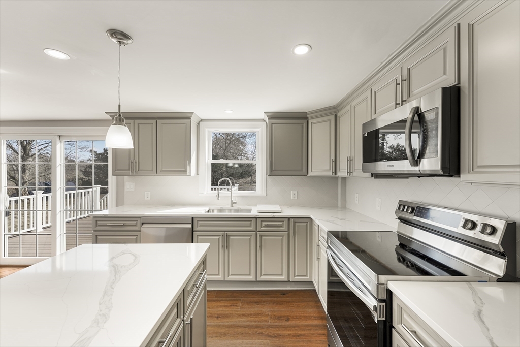 26 Maple Street Mendon, MA 01756 - Photo 4 of 42 a kitchen with stainless steel appliances a stove sink microwave and cabinets