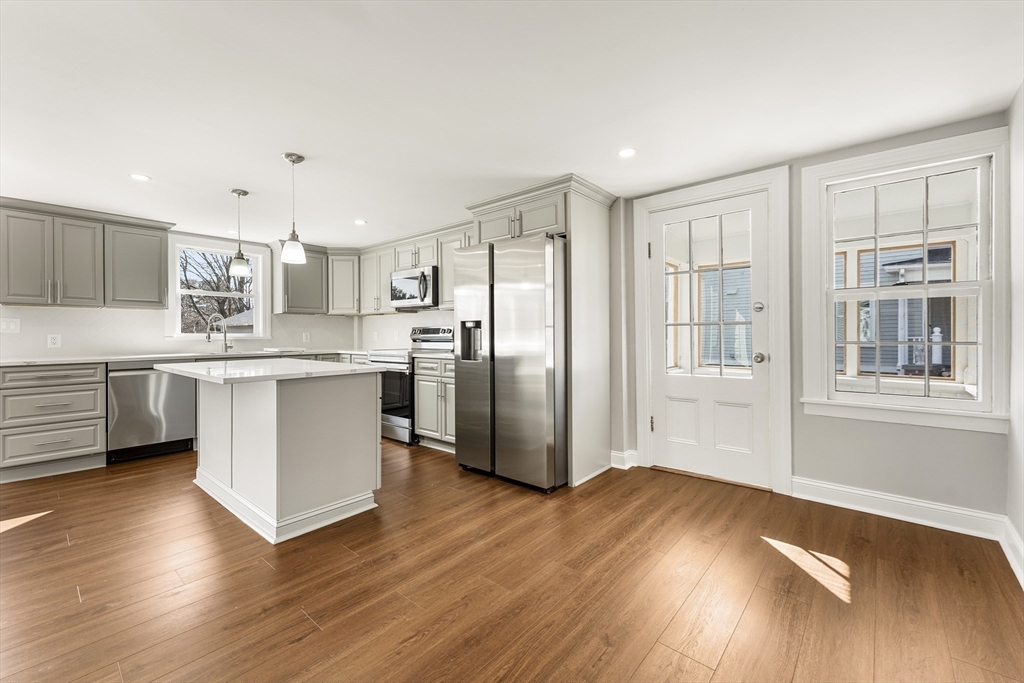 26 Maple Street Mendon, MA 01756 - Photo 8 of 42 a kitchen with stainless steel appliances a refrigerator sink and cabinets