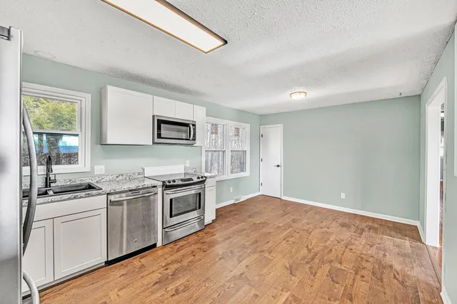 a kitchen with stainless steel appliances granite countertop a stove and a sink
