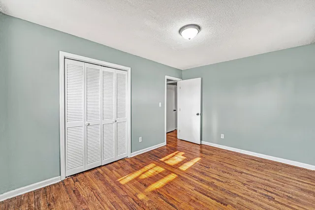 a view of a room with wooden floor