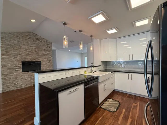 a kitchen with a sink appliances and cabinets