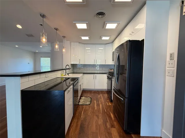 a kitchen with a refrigerator and a sink