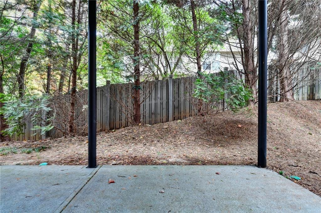 2804 Loftview Square, Unit 3 Atlanta, GA 30339 - Photo 35 of 36 a view of a backyard with large trees and wooden fence
