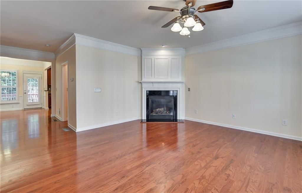2804 Loftview Square, Unit 3 Atlanta, GA 30339 - Photo 5 of 36 an empty room with wooden floor chandelier fan and windows