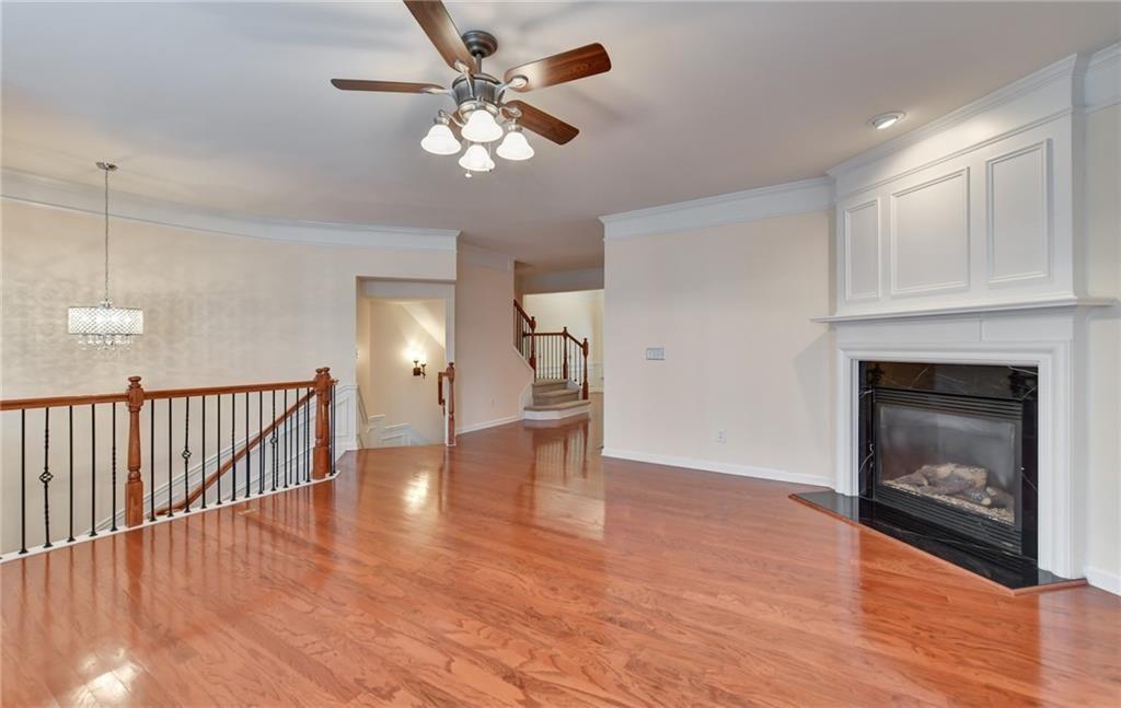 2804 Loftview Square, Unit 3 Atlanta, GA 30339 - Photo 6 of 36 a view of an empty room with wooden floor and a fireplace