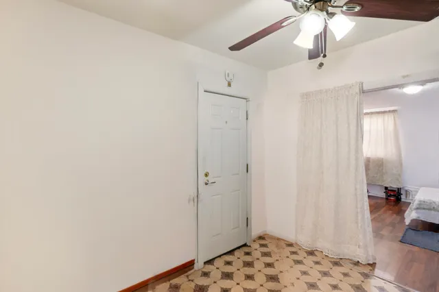 a view of a bedroom with wooden floor and cabinet