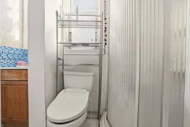 a bedroom with a bed and a chair