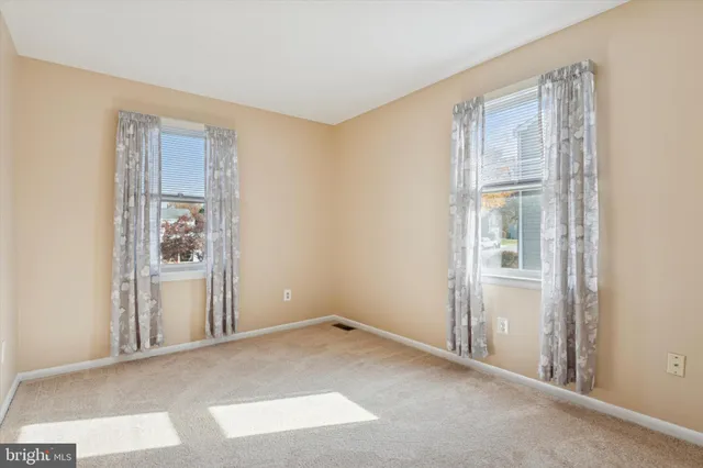 a view of an empty room with closet area