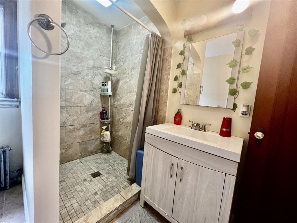 29 Brookfield Road, Unit 1 Sturbridge, MA 01518 - Photo 6 of 9 a bathroom with a sink vanity granite and shower