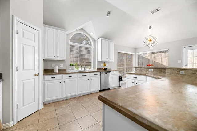 a kitchen with sink refrigerator and cabinets