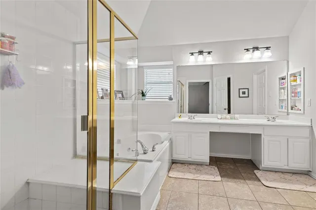 a bathroom with a tub sink and mirror
