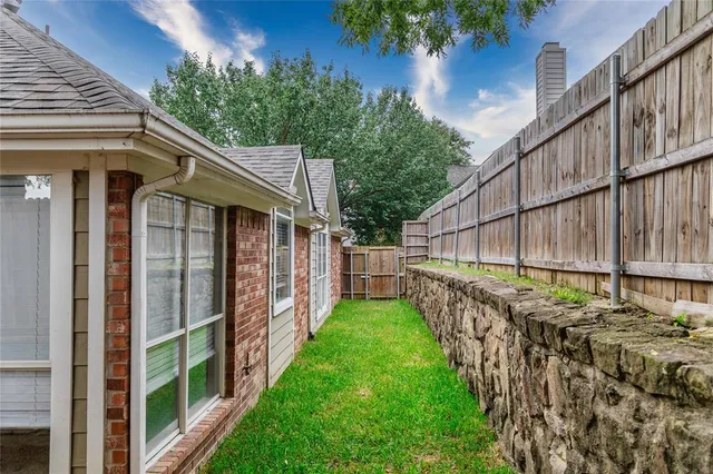 a view of a small house with a yard