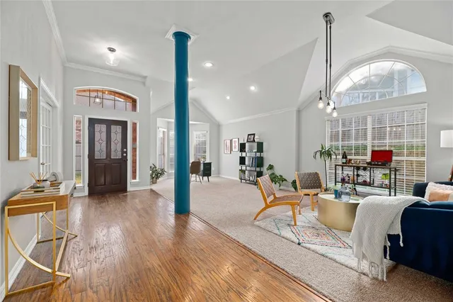 a living room with furniture a table and wooden floor