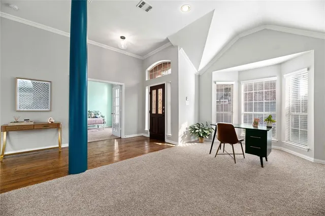 a view of a livingroom with furniture and a large window