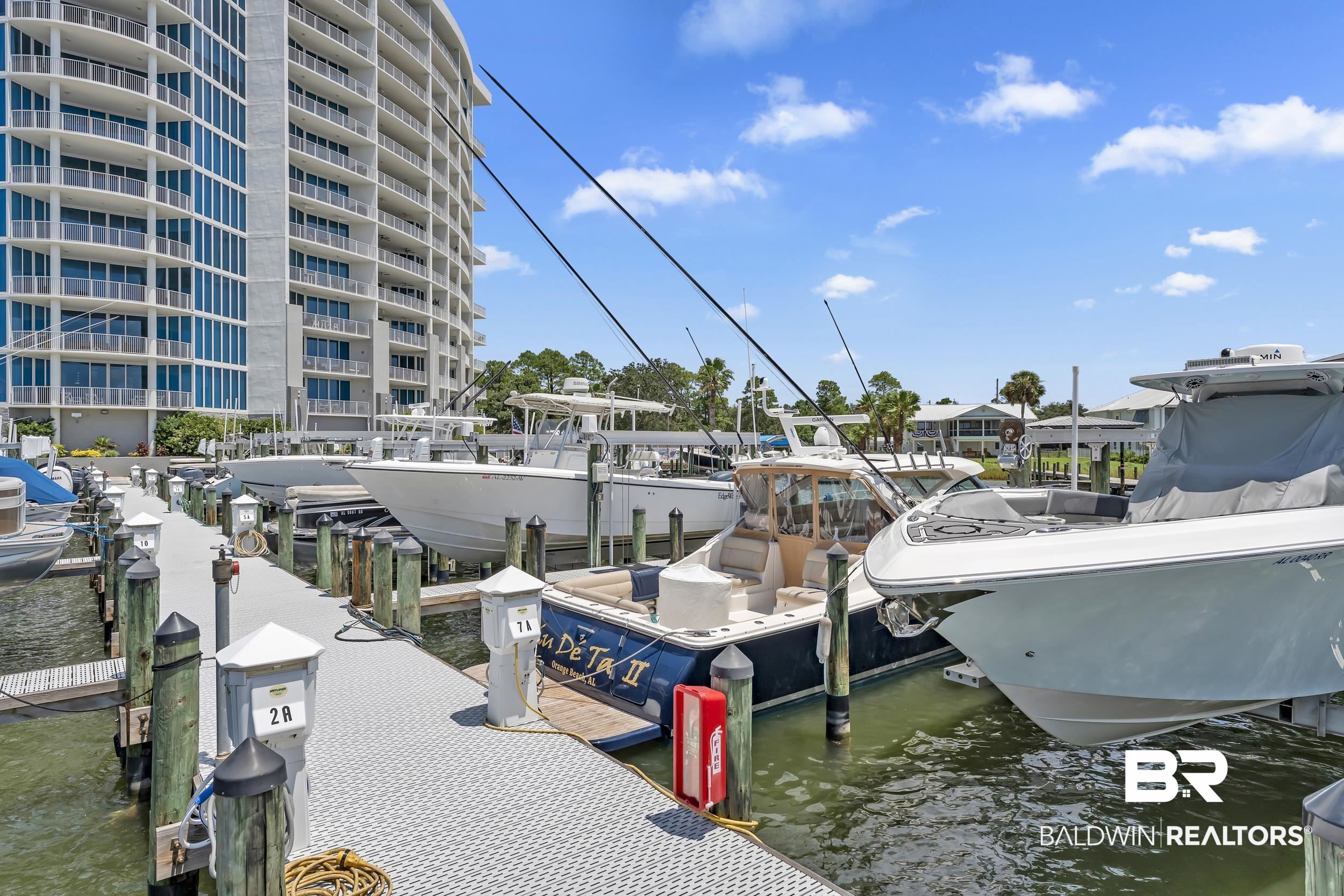 28250 Canal Road, Unit 307 Orange Beach, AL 36561 - Photo 15 of 56 Dock area featuring a water view and boat lift