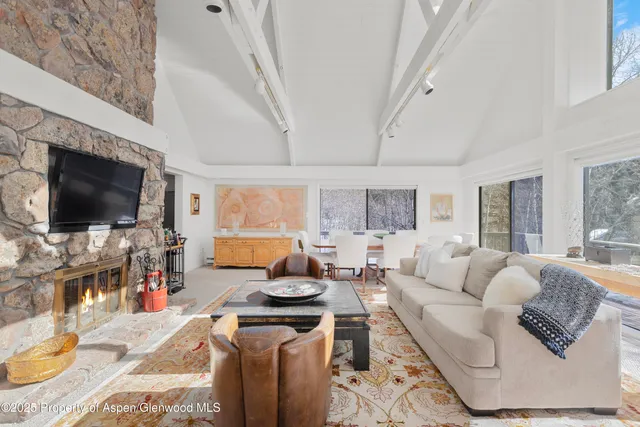 a living room with fireplace furniture and a flat screen tv