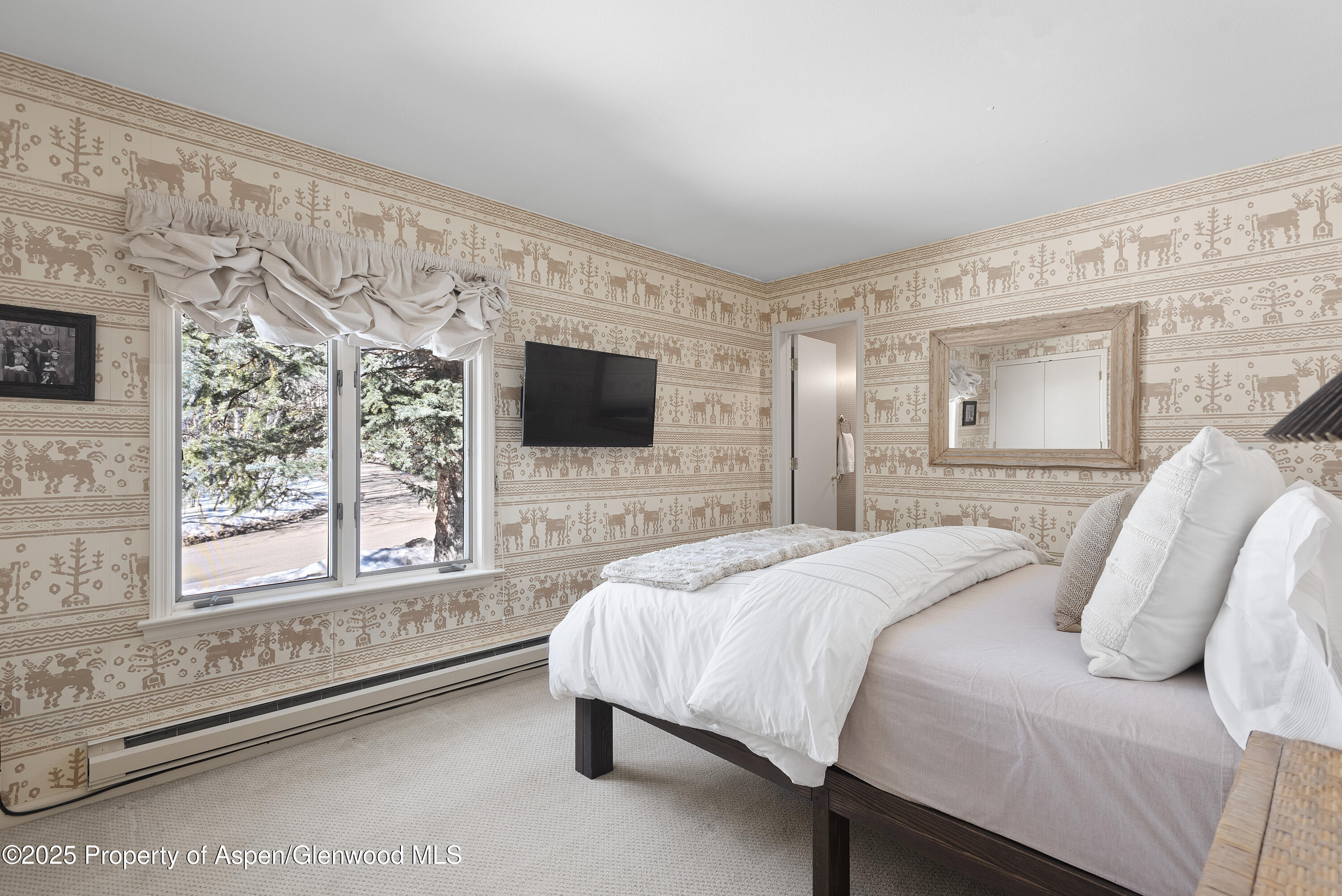 60 Northway Drive Aspen, CO 81611 - Photo 14 of 32 a spacious bedroom with a bed and a flat screen tv