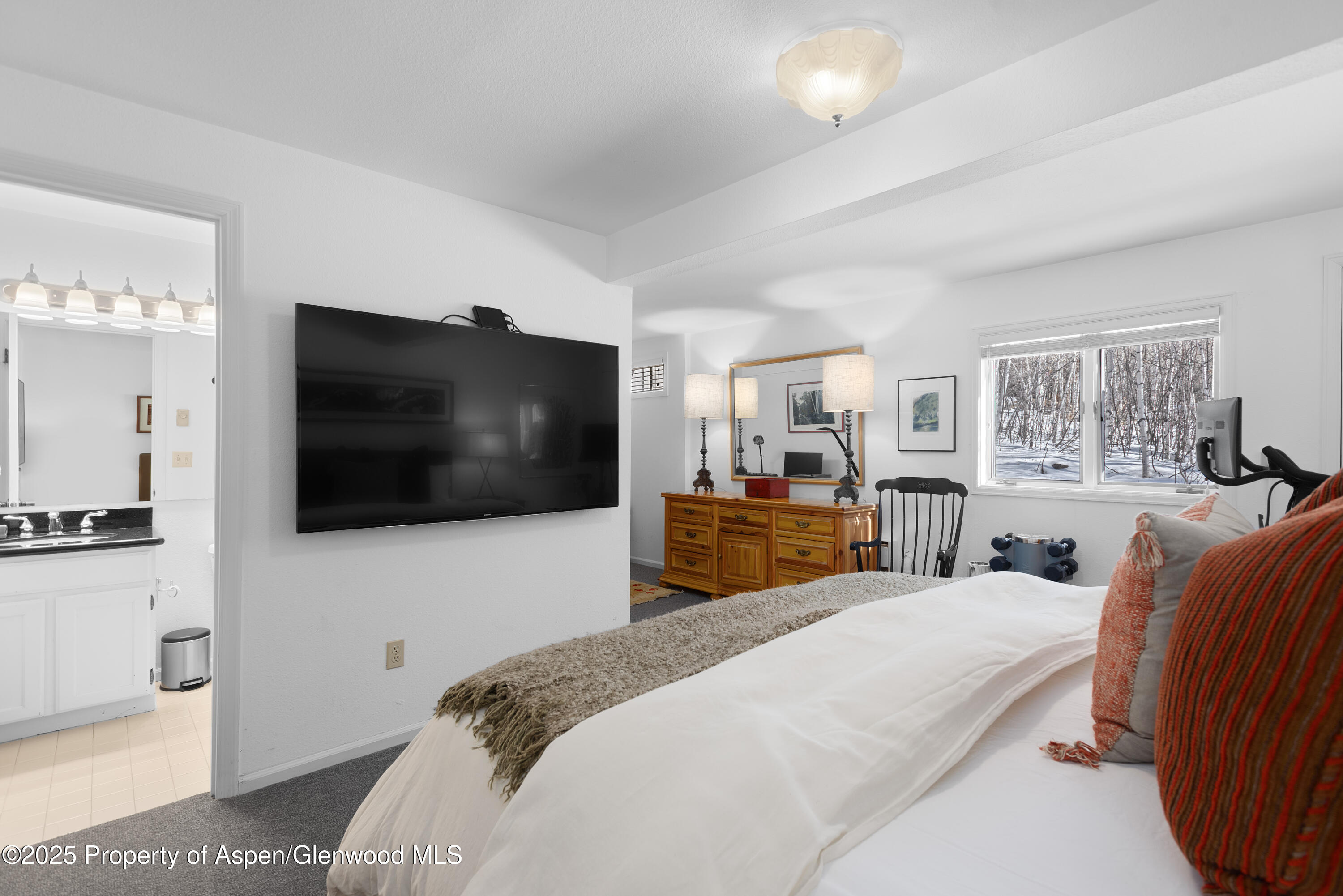 60 Northway Drive Aspen, CO 81611 - Photo 22 of 32 a bedroom with a bed a television and a large window