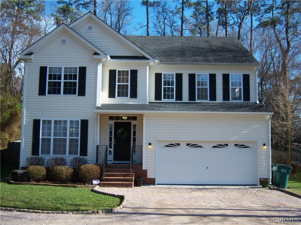 a view of a white house with large windows