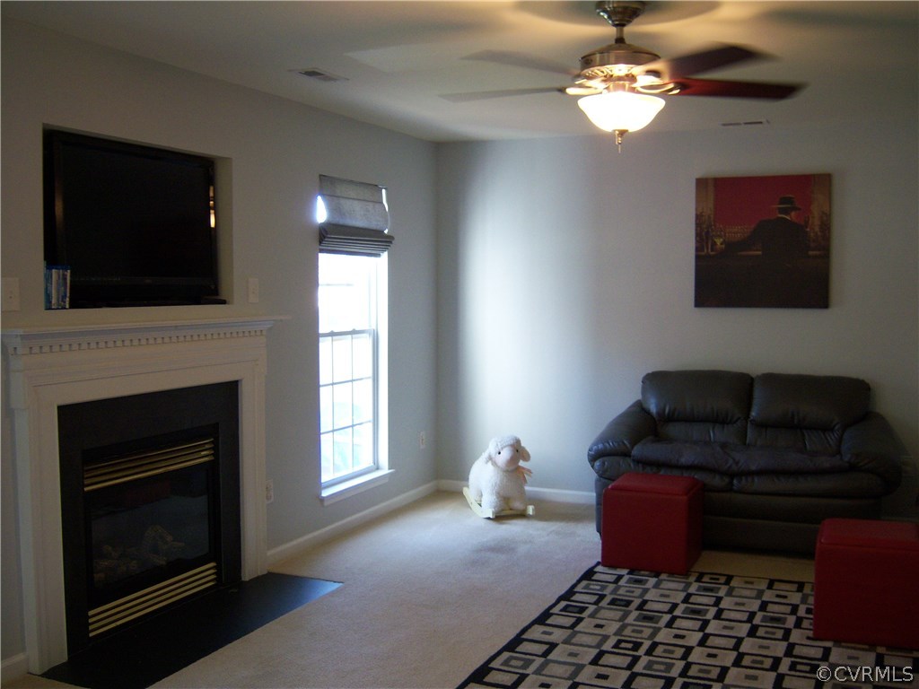 2115 Pemberton Road Henrico, VA 23238 - Photo 13 of 33 a living room with furniture a fireplace and a flat screen tv