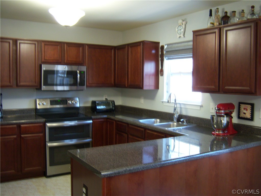 2115 Pemberton Road Henrico, VA 23238 - Photo 7 of 33 a kitchen with granite countertop a sink stainless steel appliances and cabinets