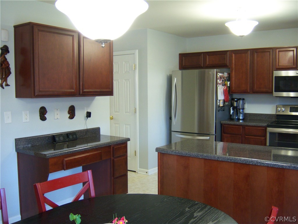 2115 Pemberton Road Henrico, VA 23238 - Photo 8 of 33 a kitchen with granite countertop a refrigerator stove and microwave