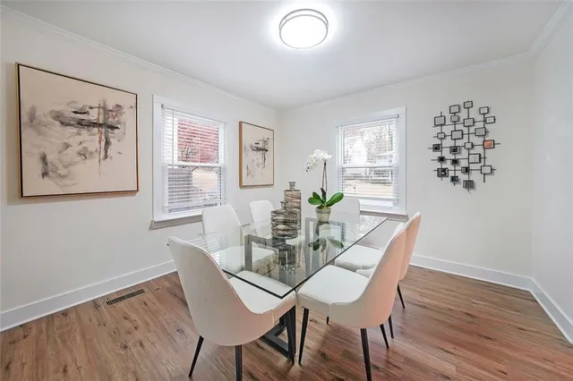 a view of a dining room with furniture window and wooden floor