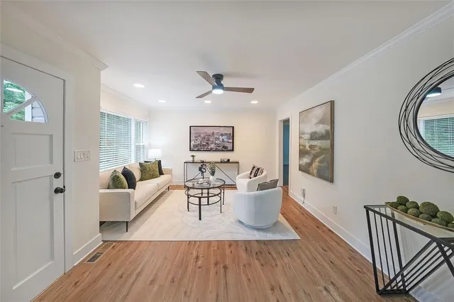 a living room with furniture and a wooden floor