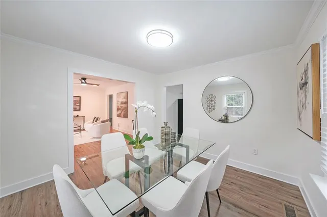 a view of a dining room with furniture and a mirror