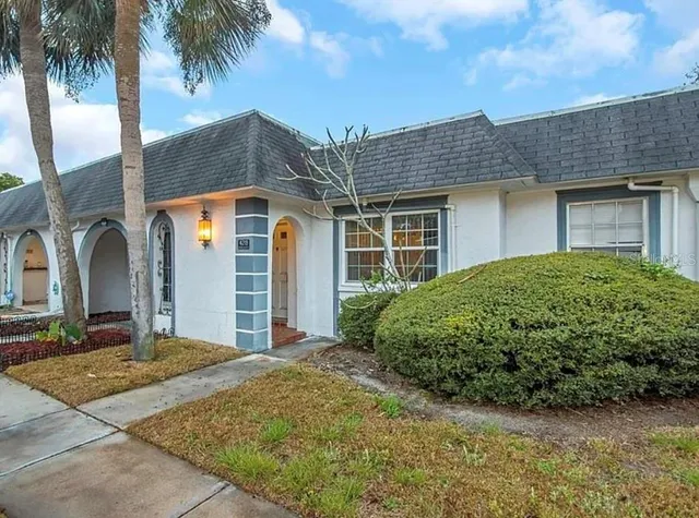 a front view of a house with a garden