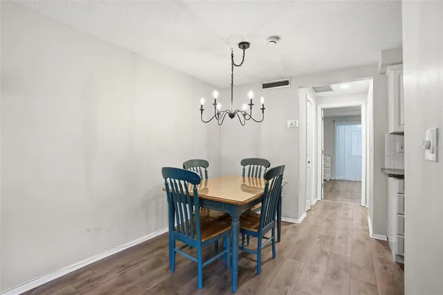 a view of a dining room with furniture and chandelier